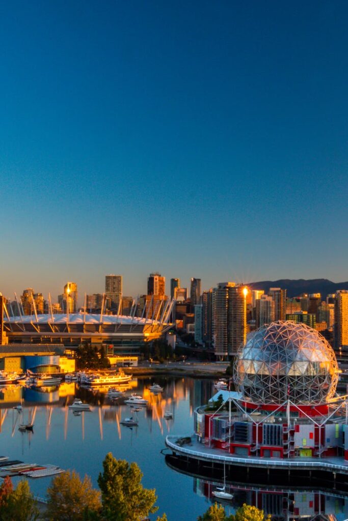 pexels-photo-2382868-2382868-1 Vibrant sunset view of Vancouver's skyline, featuring Science World and cityscape reflections.